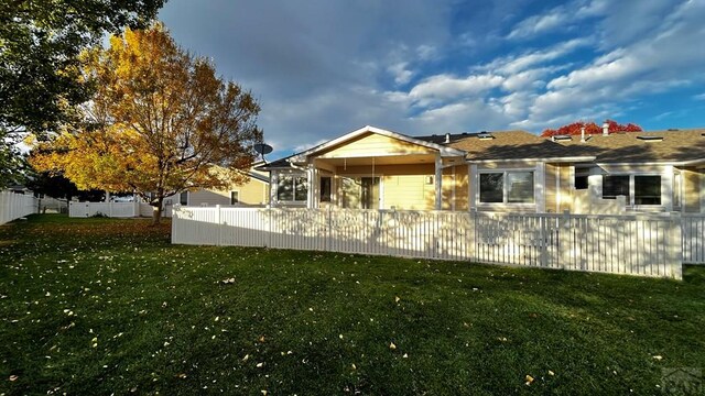 view of side of property featuring fence private yard and a yard