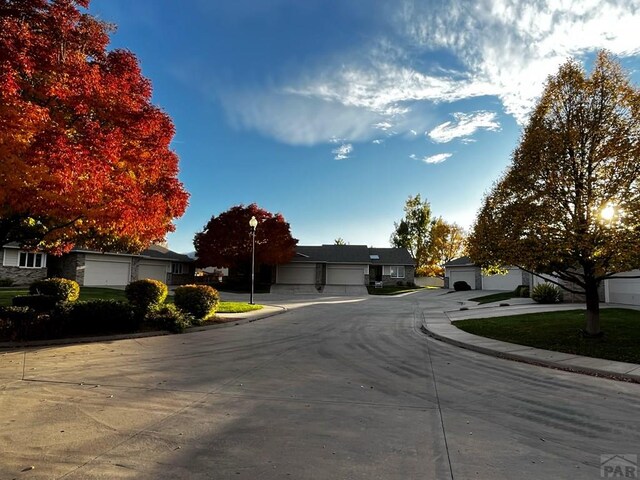 view of road featuring curbs, street lighting, and sidewalks