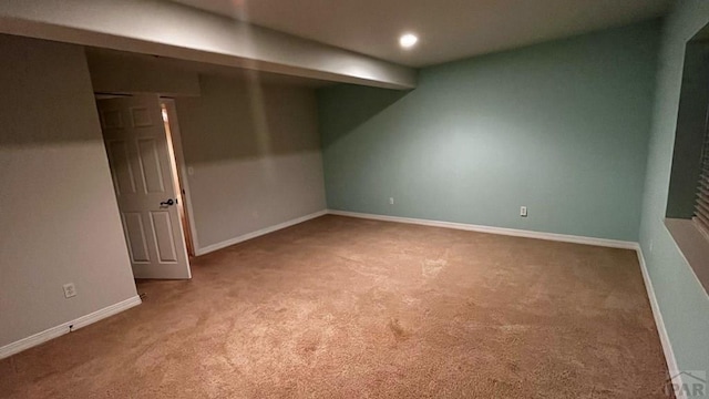 finished basement featuring light carpet, recessed lighting, and baseboards