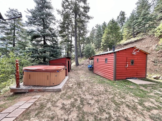 view of yard featuring an outdoor structure and a hot tub