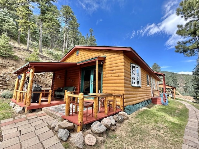 view of property exterior with log veneer siding