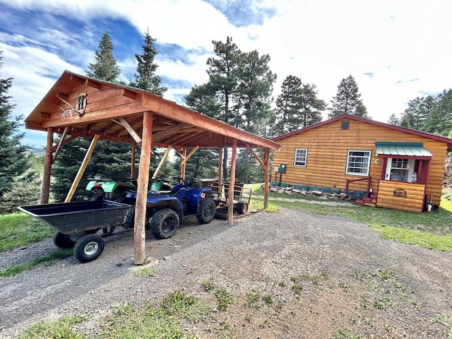 view of car parking with driveway and a detached carport