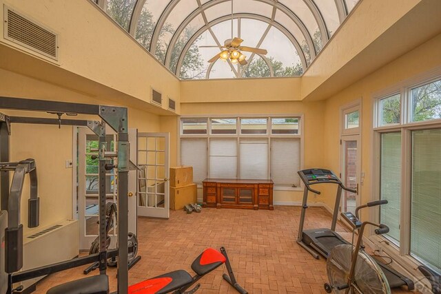 workout room featuring plenty of natural light, visible vents, and ceiling fan