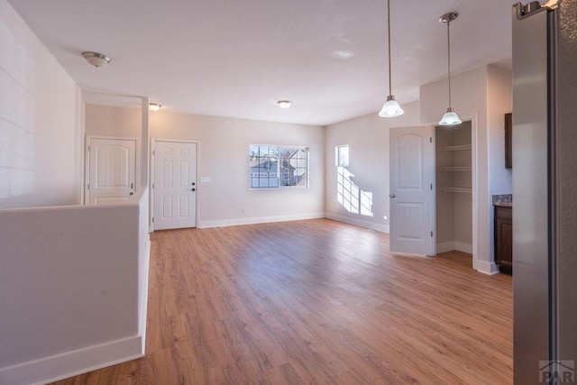 unfurnished room featuring light wood-style floors and baseboards