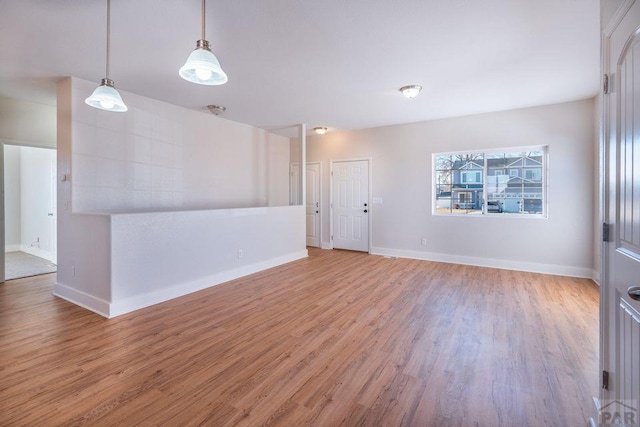 unfurnished room featuring light wood-style floors and baseboards