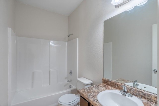 bathroom featuring toilet, tub / shower combination, and vanity