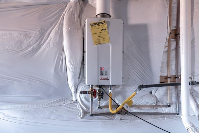 utility room featuring tankless water heater