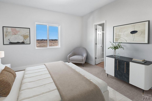 carpeted bedroom featuring baseboards