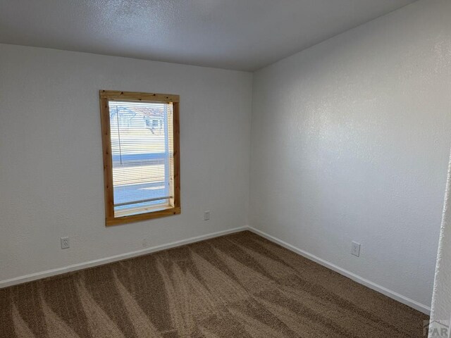 spare room with carpet floors and baseboards