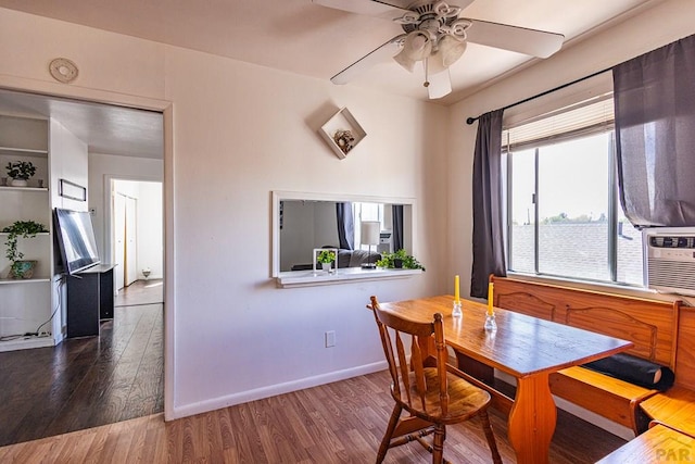 dining space featuring dark wood-style floors, ceiling fan, and baseboards