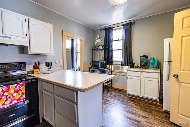 kitchen featuring a peninsula, white cabinetry, light countertops, and black range with electric stovetop