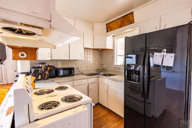 kitchen with decorative backsplash, light countertops, black appliances, and white cabinetry