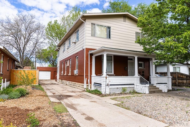 view of front of house featuring an outbuilding, brick siding, fence, and a garage