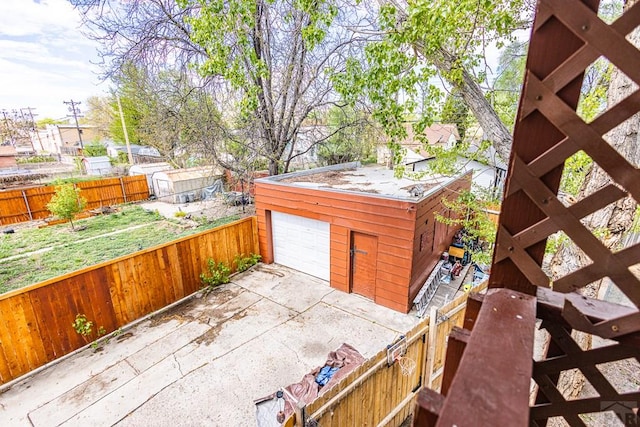 exterior space featuring concrete driveway and fence