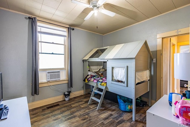 bedroom with baseboards, dark wood finished floors, a ceiling fan, ornamental molding, and cooling unit