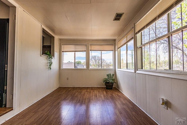 unfurnished sunroom with plenty of natural light and visible vents