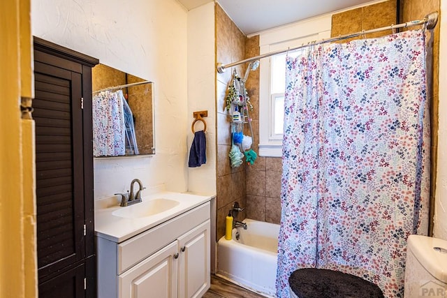 bathroom with vanity, toilet, and shower / tub combo with curtain