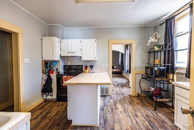 kitchen featuring under cabinet range hood, black range with electric stovetop, white cabinets, light countertops, and dark wood finished floors