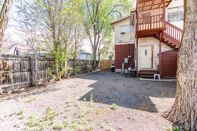 view of yard with entry steps and a fenced backyard