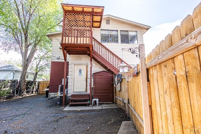 exterior space featuring entry steps, brick siding, and fence