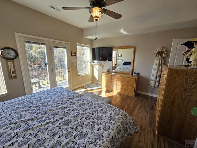 bedroom featuring visible vents, multiple windows, dark wood finished floors, and access to outside