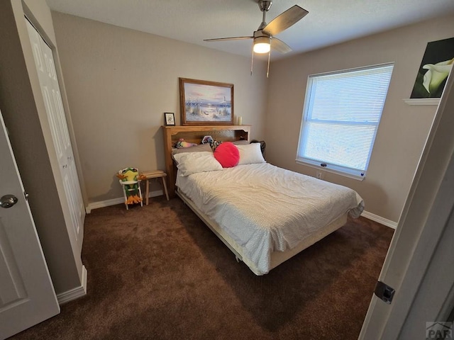 bedroom featuring a closet, ceiling fan, baseboards, and dark colored carpet