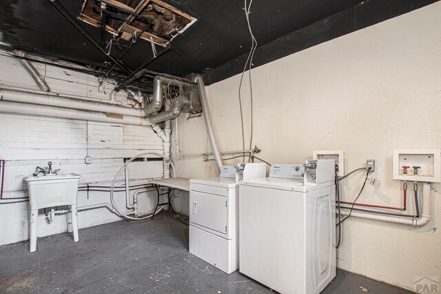 laundry area with washer and dryer and a sink