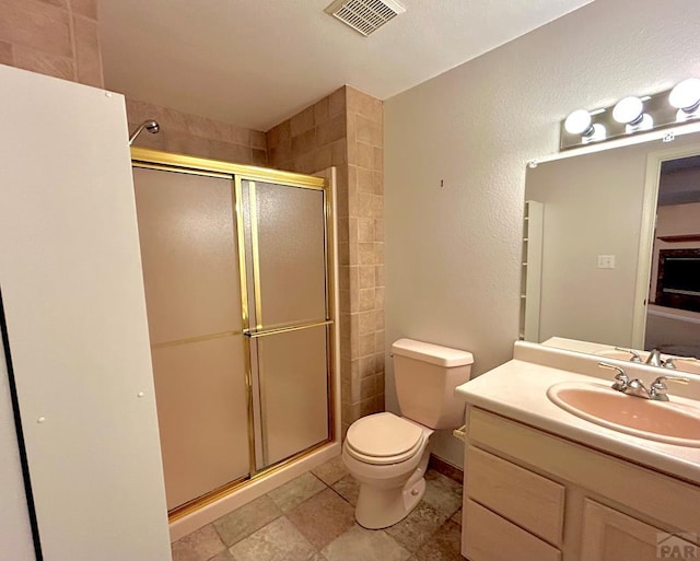 465 W Palmer Lake Dr, Pueblo West, CO 81007 - full bath featuring a stall shower, toilet, vanity, and a textured wall