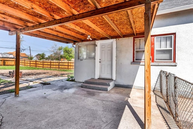 710 Wilson Ave, Pueblo, CO 81004 - doorway to property with stucco siding, fence, and a patio