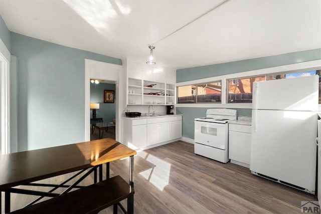 kitchen featuring white appliances, wood finished floors, light countertops, white cabinetry, and open shelves