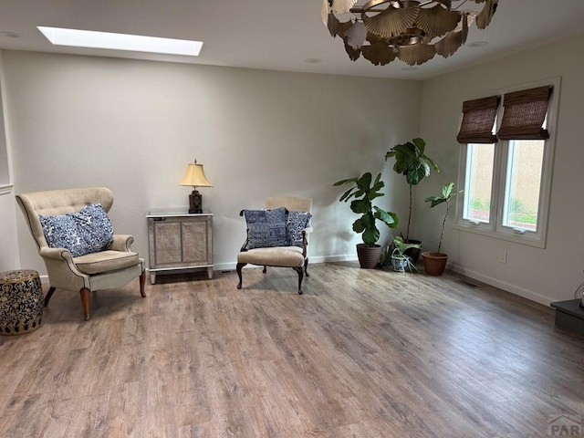 1318 Paseo Del Norte, Pueblo, CO 81008 - sitting room featuring a skylight, wood finished floors, and baseboards