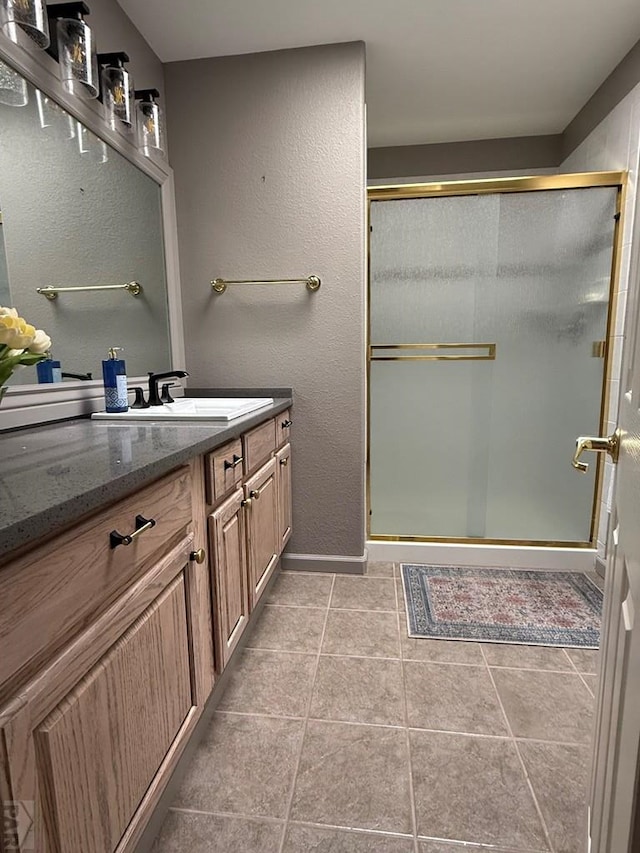 1318 Paseo Del Norte, Pueblo, CO 81008 - full bathroom featuring a stall shower, vanity, baseboards, and tile patterned floors
