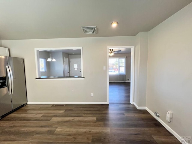 kitchen featuring dark wood-style floors, baseboards, visible vents, and stainless steel fridge with ice dispenser