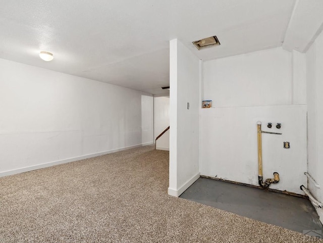 basement featuring dark carpet and baseboards