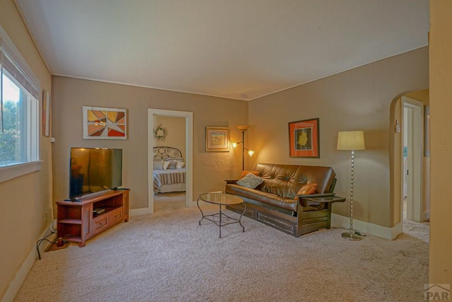 328 Colorado Ave, Walsenburg, CO 81089 - living room featuring arched walkways, baseboards, and carpet
