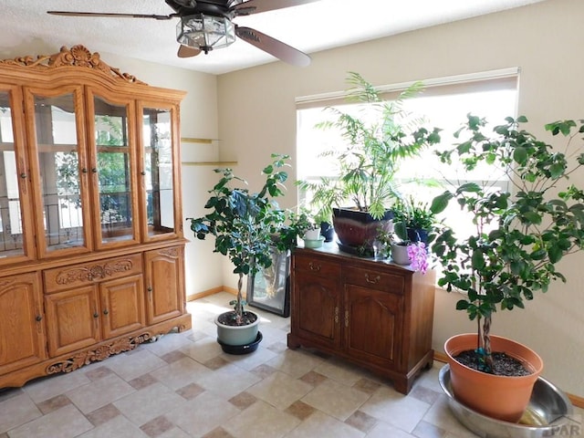 6 Ironweed Dr, Pueblo, CO 81001 - living area featuring baseboards, a ceiling fan, and stone finish floor