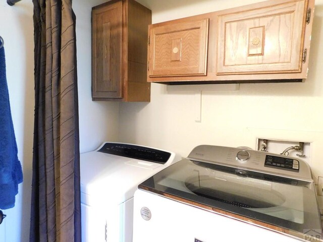 6 Ironweed Dr, Pueblo, CO 81001 - laundry area with washer and dryer and cabinet space