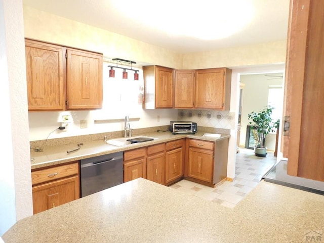 6 Ironweed Dr, Pueblo, CO 81001 - kitchen featuring a sink, light countertops, a toaster, dishwasher, and light floors