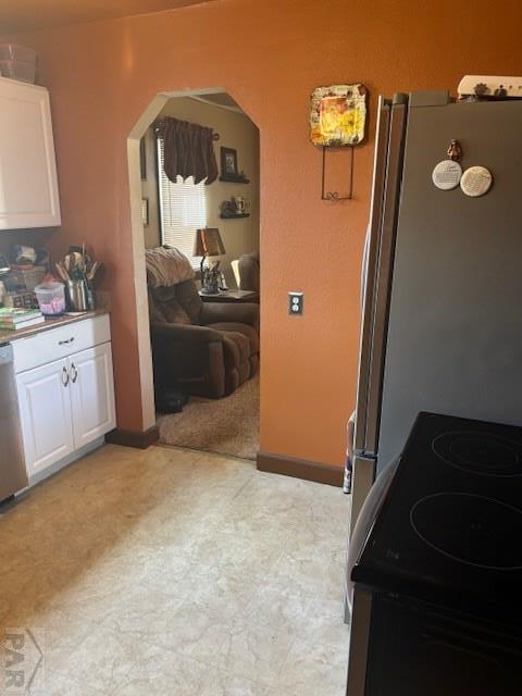2008 N Main St, Pueblo, CO 81003 - kitchen featuring white cabinets, electric range, dishwasher, arched walkways, and light floors