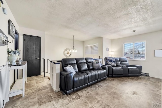 living room with a textured ceiling, baseboards, and an inviting chandelier