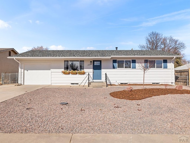 single story home with entry steps, driveway, an attached garage, and fence