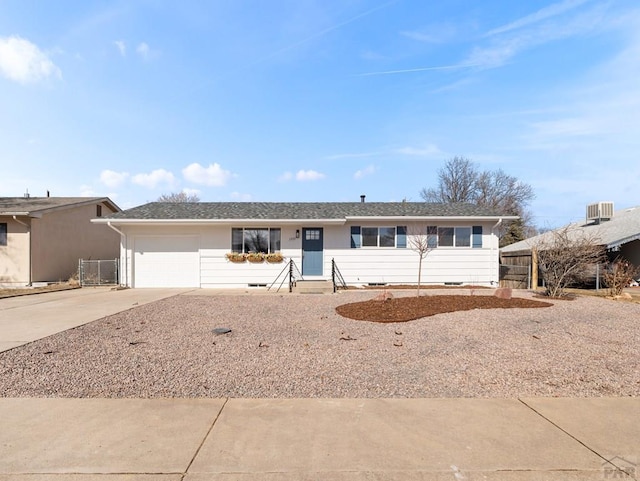 single story home featuring entry steps, concrete driveway, an attached garage, and central air condition unit