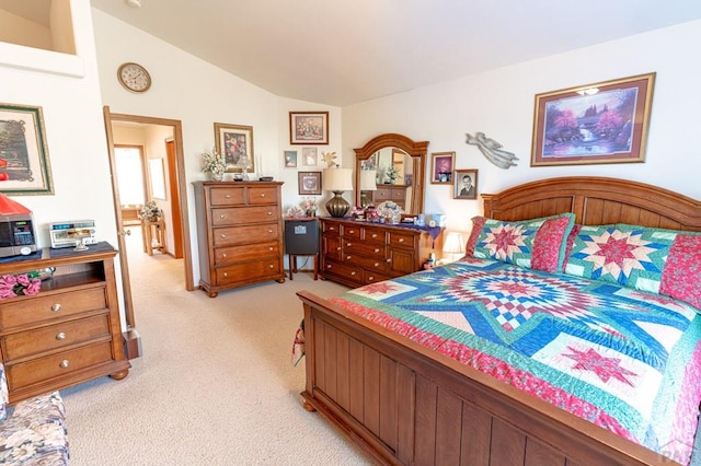 bedroom with light colored carpet and vaulted ceiling