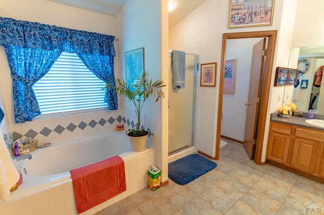 full bath with lofted ceiling, tile patterned floors, a garden tub, vanity, and a shower stall