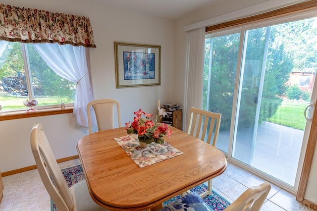 dining room with light tile patterned floors and baseboards