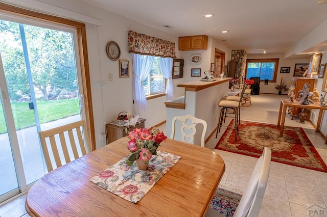 dining space with light tile patterned floors, visible vents, and recessed lighting