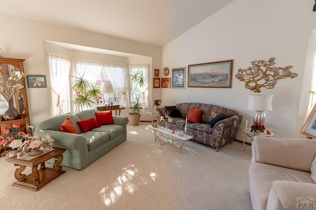 living area featuring carpet floors and vaulted ceiling