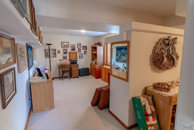 office area featuring light colored carpet and baseboards