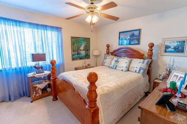 bedroom featuring light carpet and ceiling fan