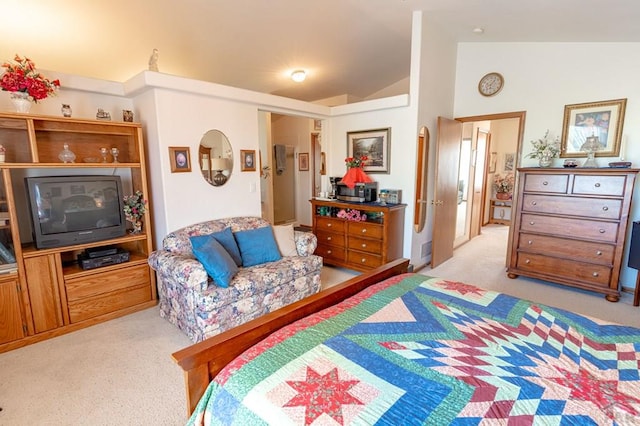 bedroom with lofted ceiling and light carpet